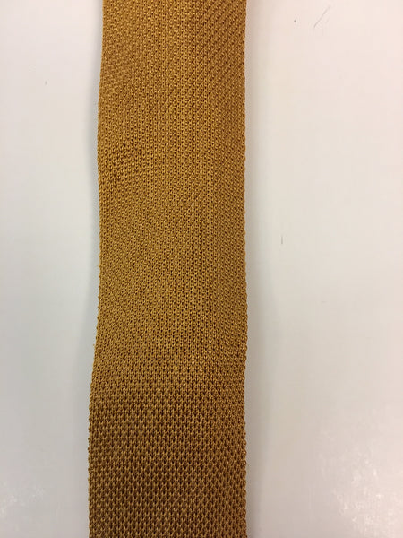 Close up of mustard knitted silk tie