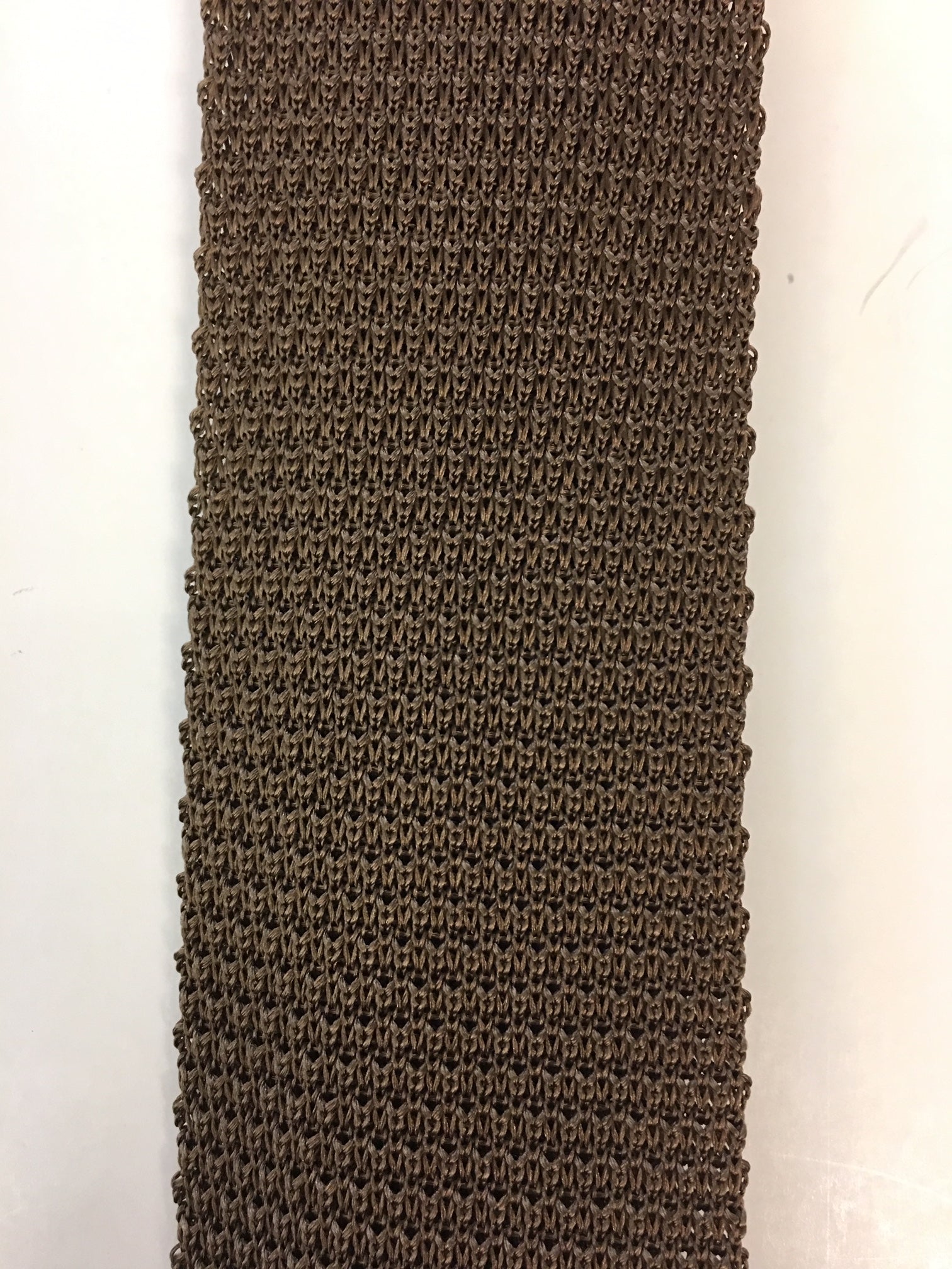 Close up of plain nutmeg knitted silk tie
